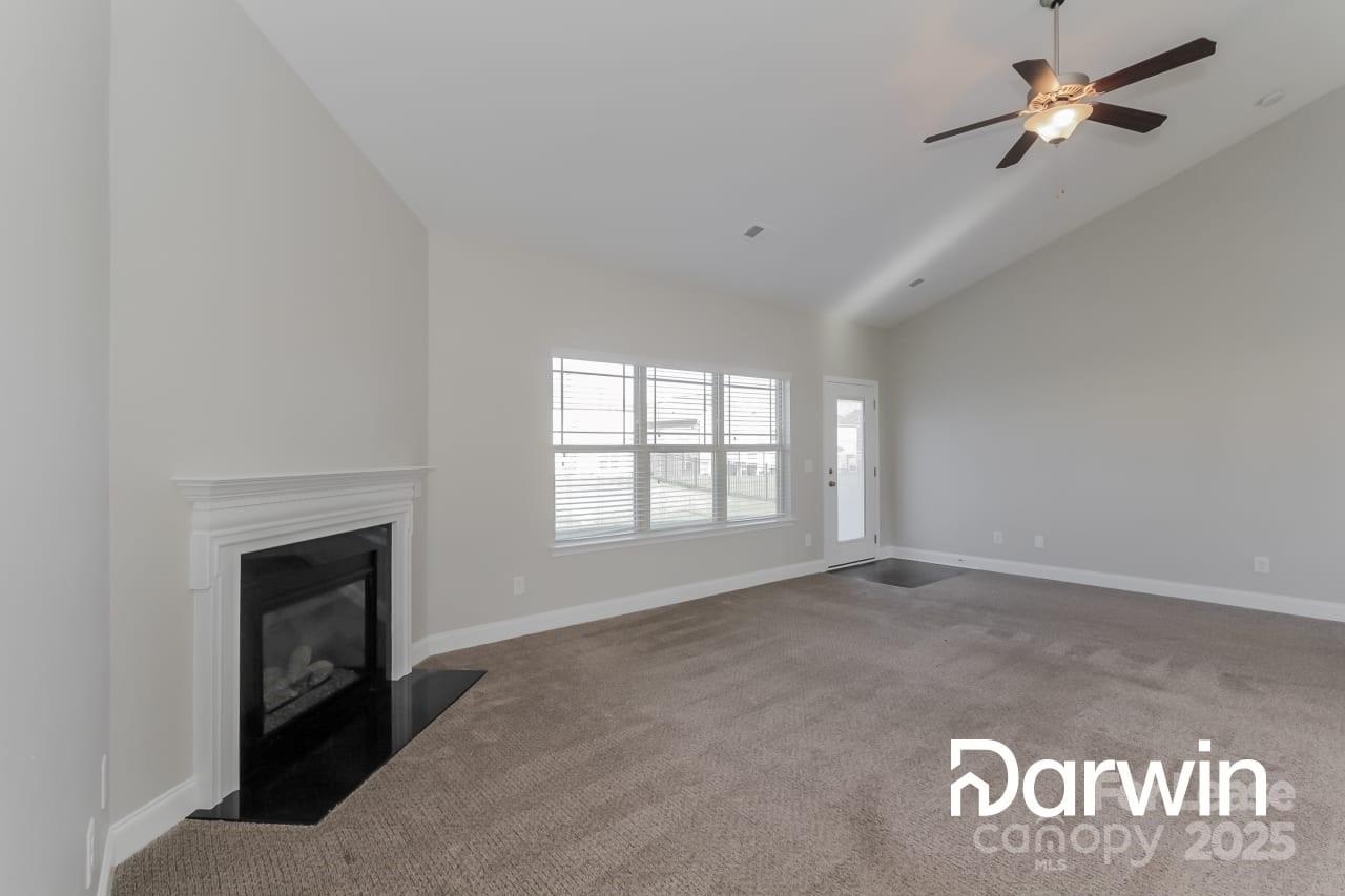 147 Water Ski Drive Statesville, NC 28677 - Photo 5 of 12 a view of an empty room with a fireplace and a window