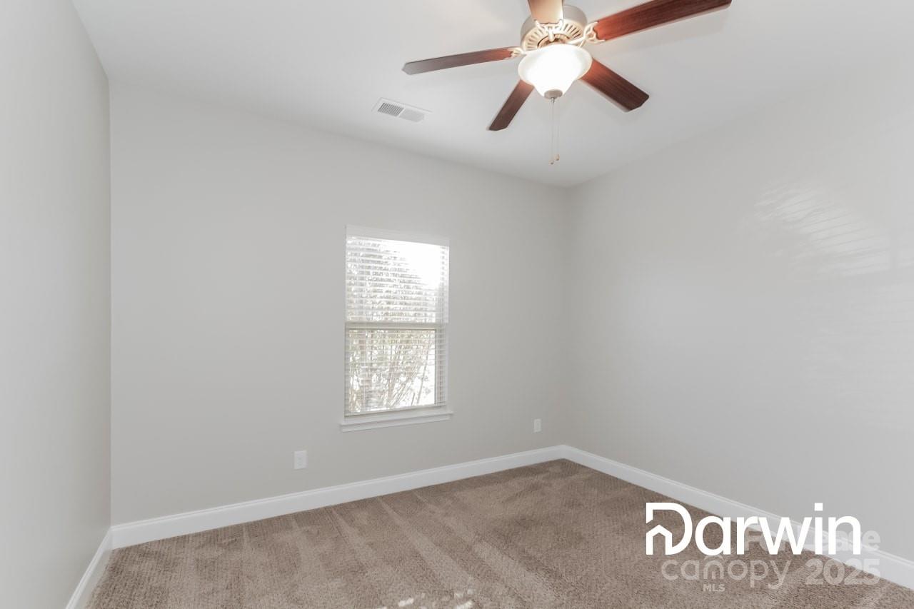 147 Water Ski Drive Statesville, NC 28677 - Photo 8 of 12 an empty room with windows and fan