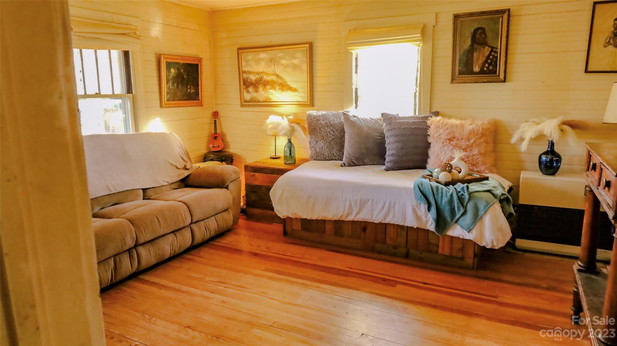 680 Cedar Hill Road Alexander, NC 28701 - Photo 3 of 17 a bedroom with a bed and wooden floor