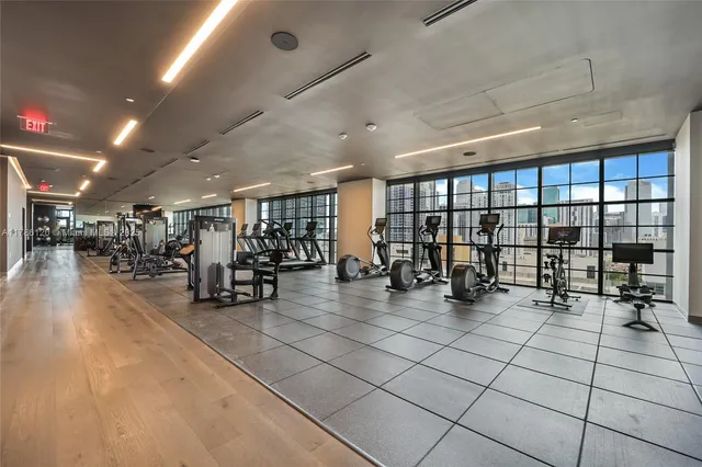 a view of a room with gym equipment and a large window