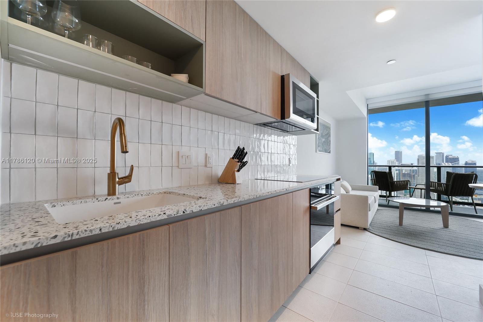 159 Northeast 6th Street, Unit 4714 Miami, FL 33132 - Photo 4 of 19 a kitchen with a sink and a stove top oven