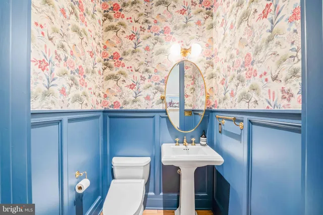 a bathroom with a double vanity sink toilet mirror and shower