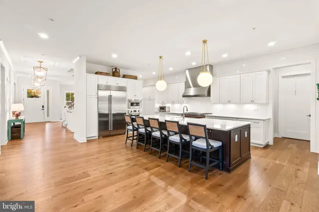 a bedroom with a bed a couch and a potted plant