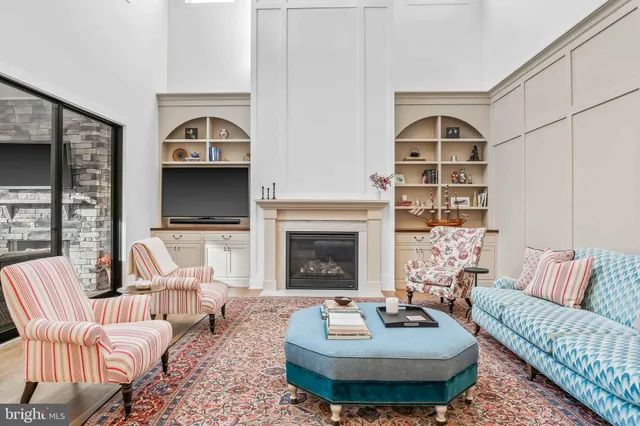 a bedroom with a bed and large windows