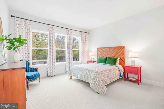 a living room with fireplace furniture and a large window