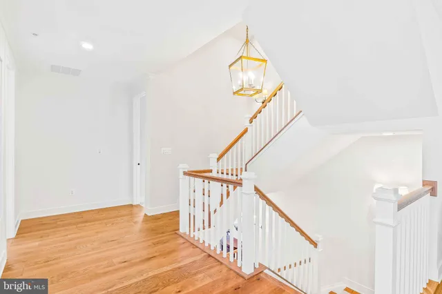 a view of a balcony with wooden floor and seating space