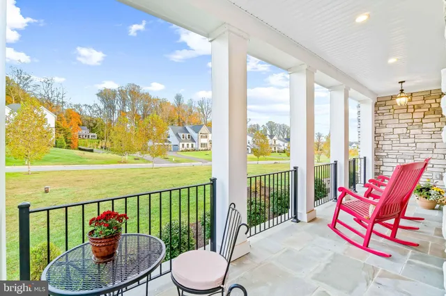 a large kitchen with stainless steel appliances kitchen island a large counter top a stove a sink and a refrigerator