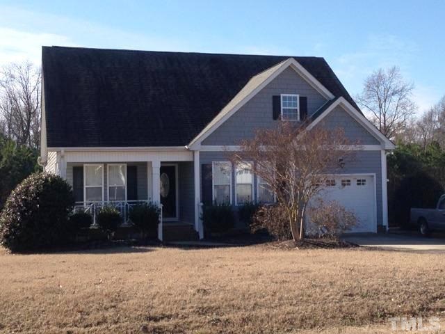 4936 Contender Drive Raleigh, NC 27603 - Photo 2 of 25 a front view of a house with a yard and garage