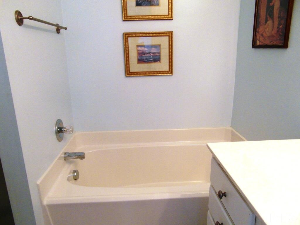 4936 Contender Drive Raleigh, NC 27603 - Photo 15 of 25 a bathroom with a tub