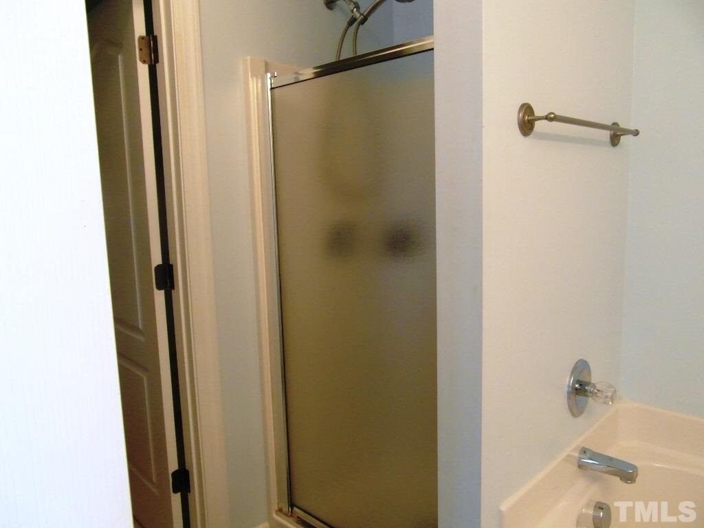 4936 Contender Drive Raleigh, NC 27603 - Photo 16 of 25 a bathroom with a shower and a sink
