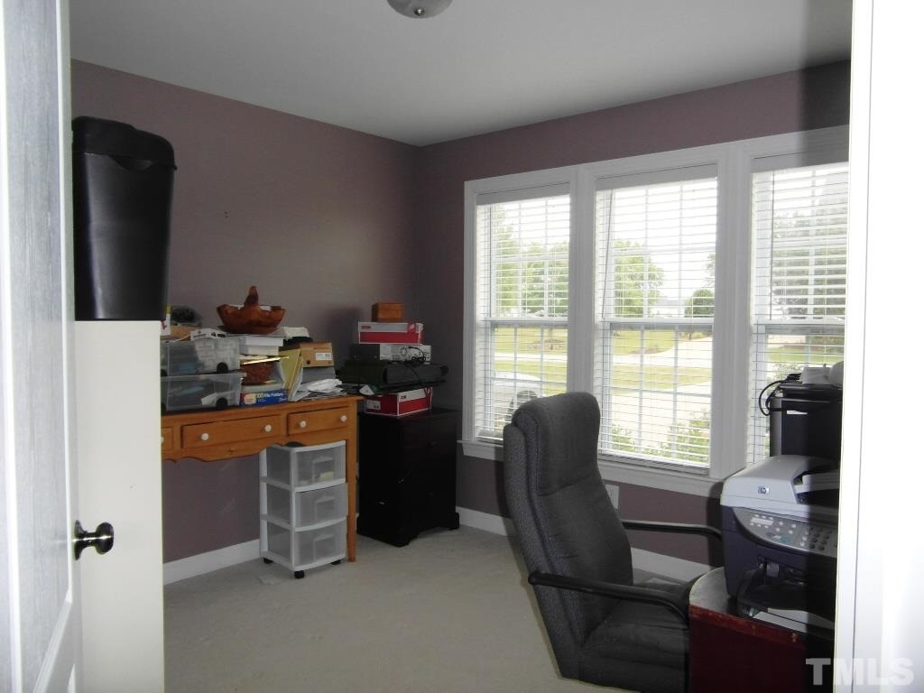 4936 Contender Drive Raleigh, NC 27603 - Photo 17 of 25 a room with furniture and a window