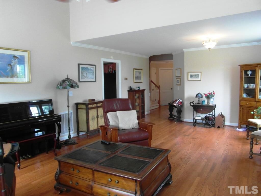 4936 Contender Drive Raleigh, NC 27603 - Photo 5 of 25 a living room with furniture and a flat screen tv