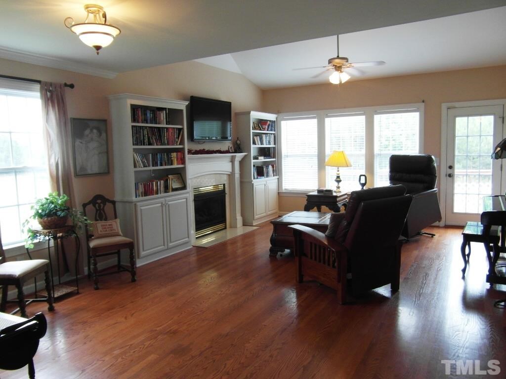 4936 Contender Drive Raleigh, NC 27603 - Photo 7 of 25 a living room with furniture and a fireplace
