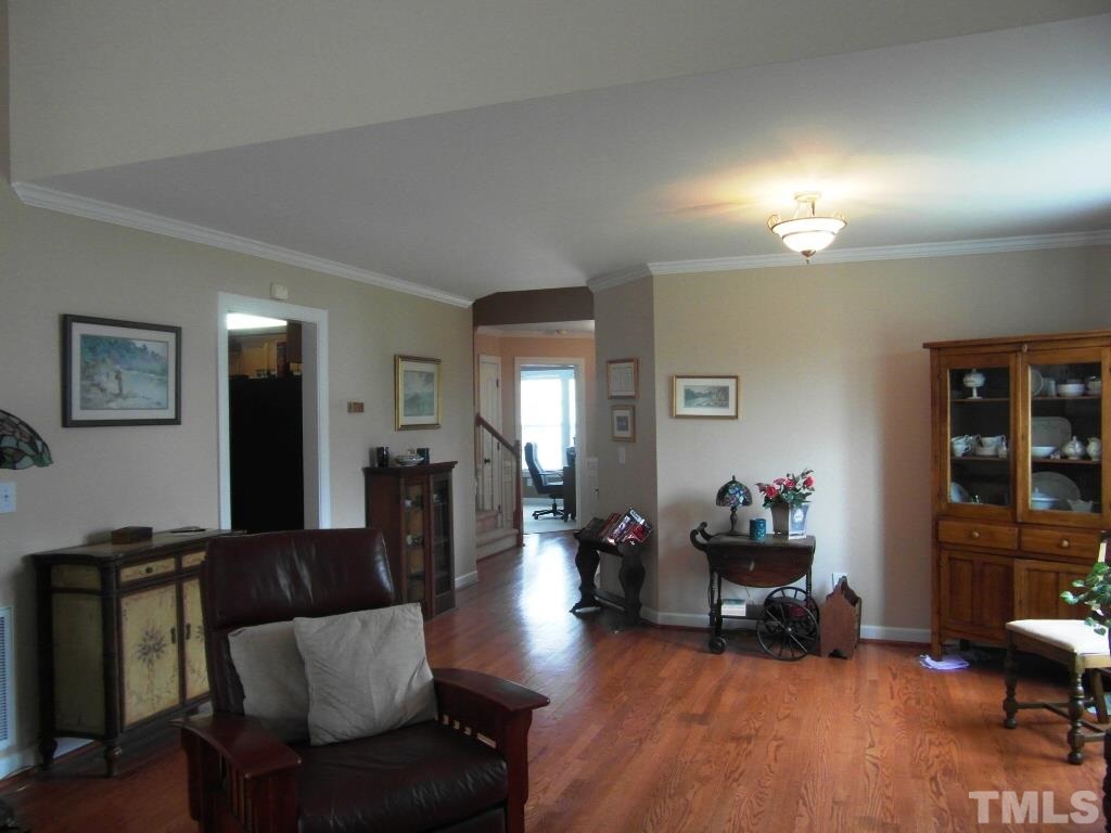 4936 Contender Drive Raleigh, NC 27603 - Photo 8 of 25 a living room with furniture and wooden floor