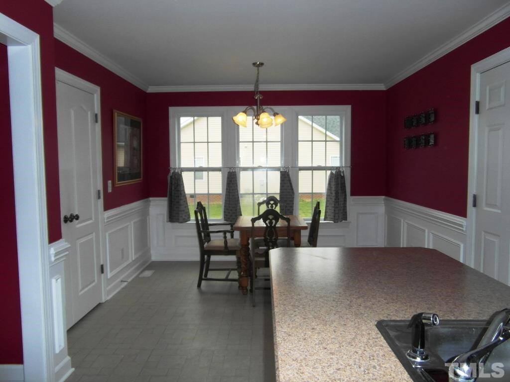 4936 Contender Drive Raleigh, NC 27603 - Photo 9 of 25 a dining room with furniture and window