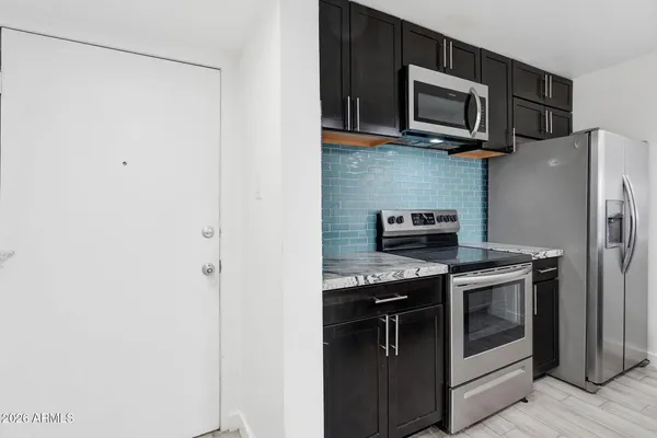 a kitchen with a stove microwave and refrigerator