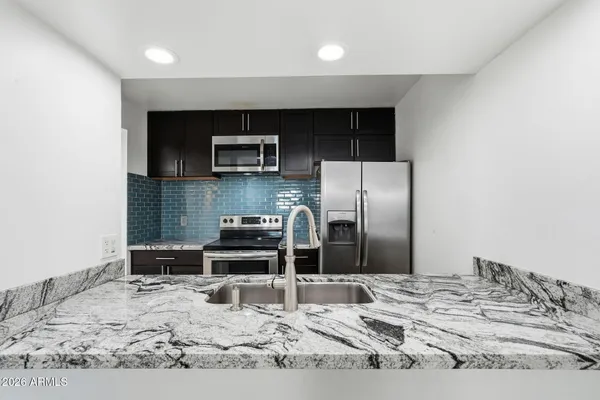 a kitchen with a sink and cabinets