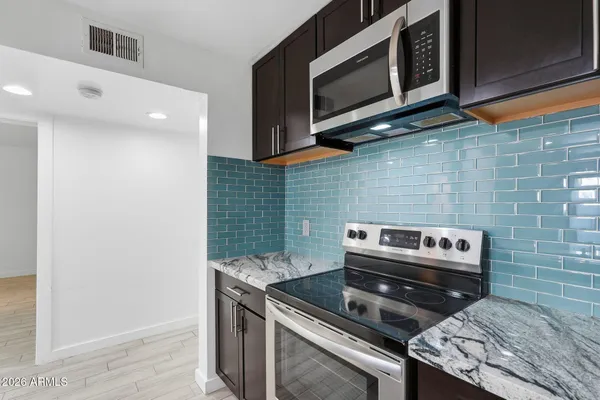 a kitchen with a stove and a microwave