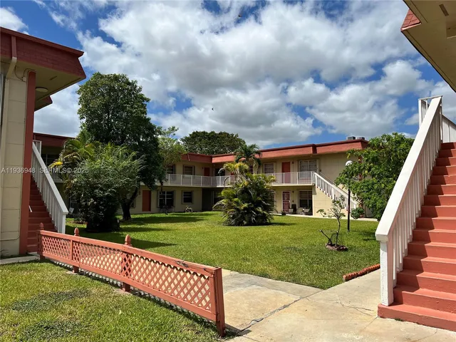 a view of house with outdoor space and garden