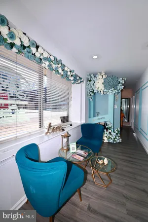 a living room with furniture dining table and a large window