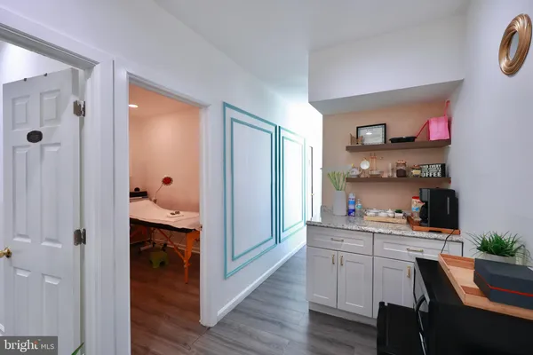 a kitchen with a wooden floor and cabinets