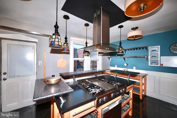 a kitchen with stainless steel appliances granite countertop a sink and a stove