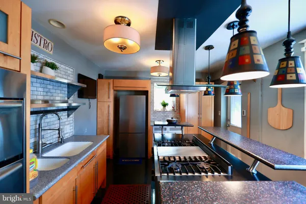 a kitchen with lots of counter space and stainless steel appliances