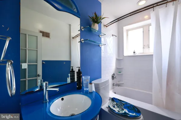 a bathroom with a sink a toilet and bathtub