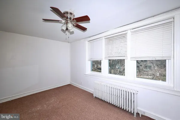 a view of a livingroom with a ceiling fan and window