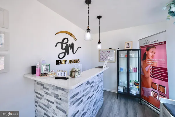 a kitchen with stainless steel appliances granite countertop a stove a sink dishwasher and a dining table with wooden floor