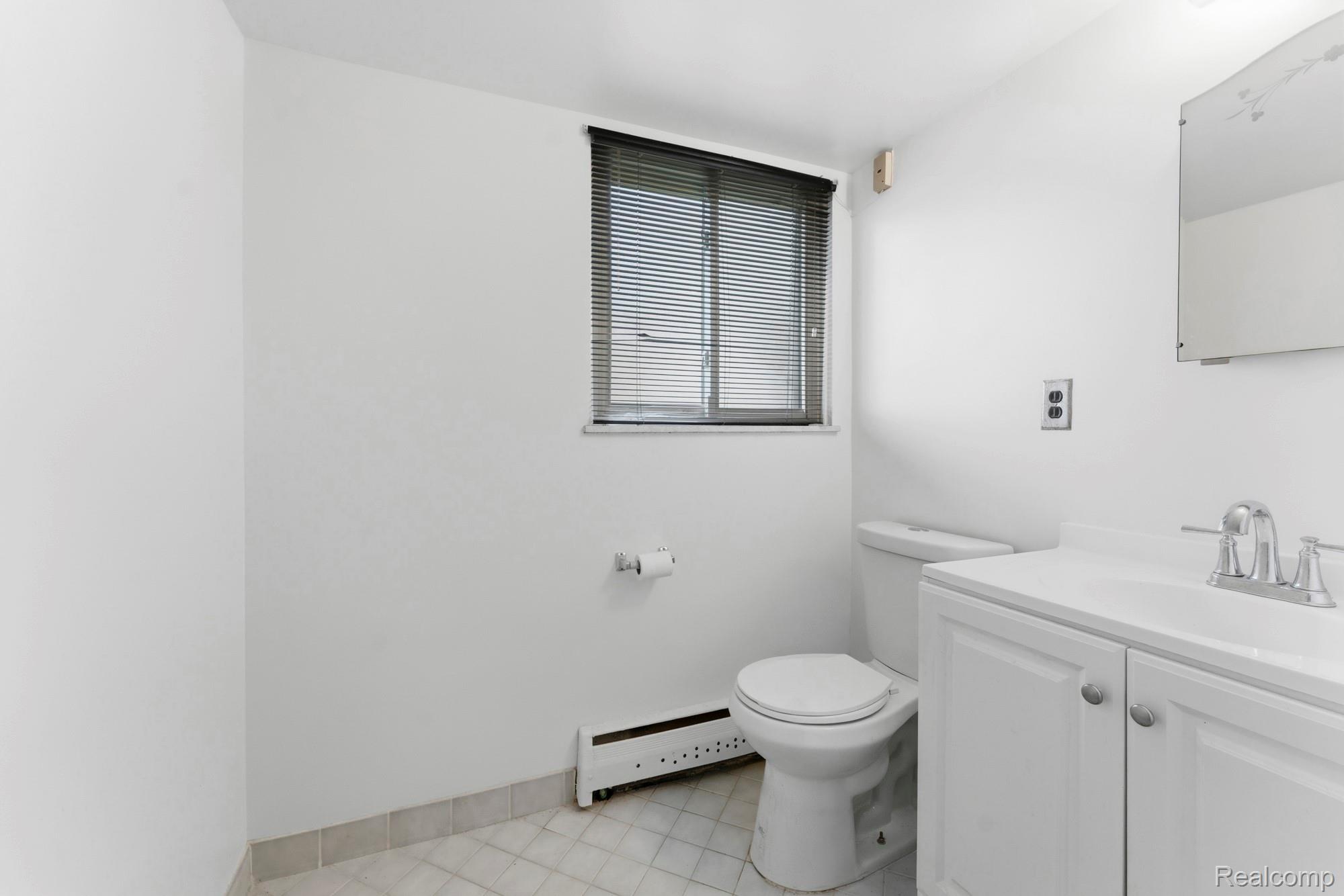 23410 Joy Road Redford, MI 48239 - Photo 14 of 25 Half bath with a baseboard radiator and vanity