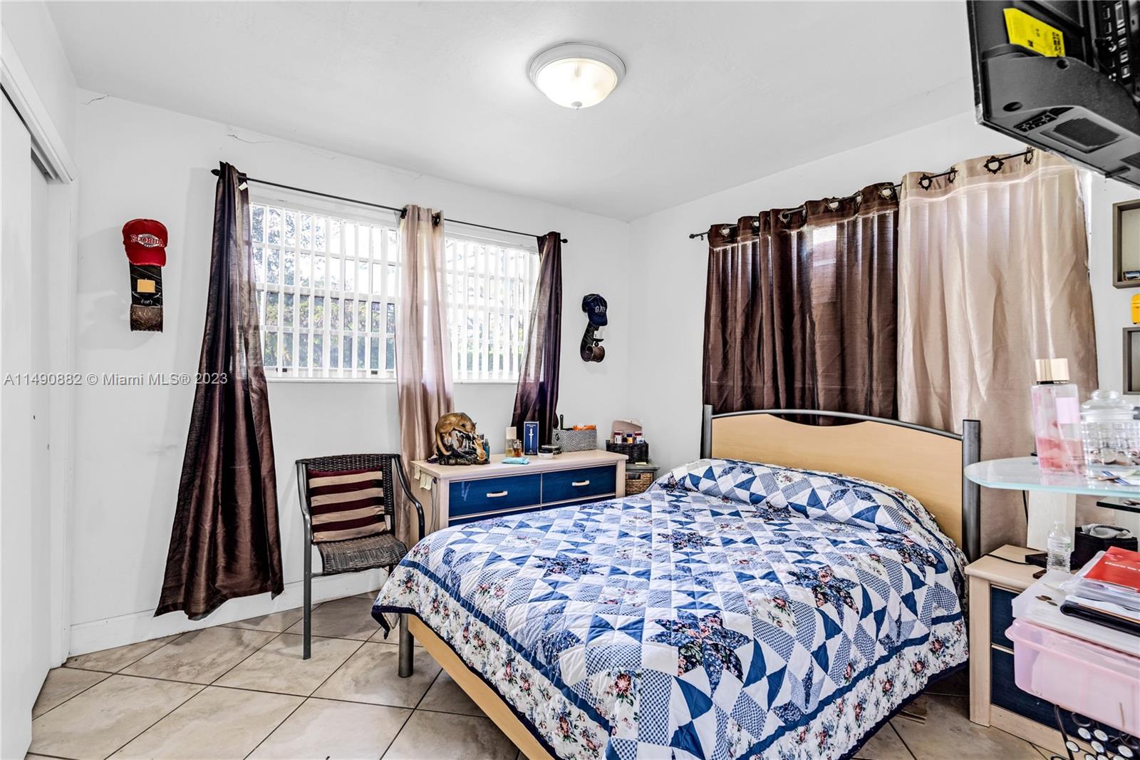 3551 Frow Avenue Miami, FL 33133 - Photo 13 of 22 a bedroom with a bed and a book shelf