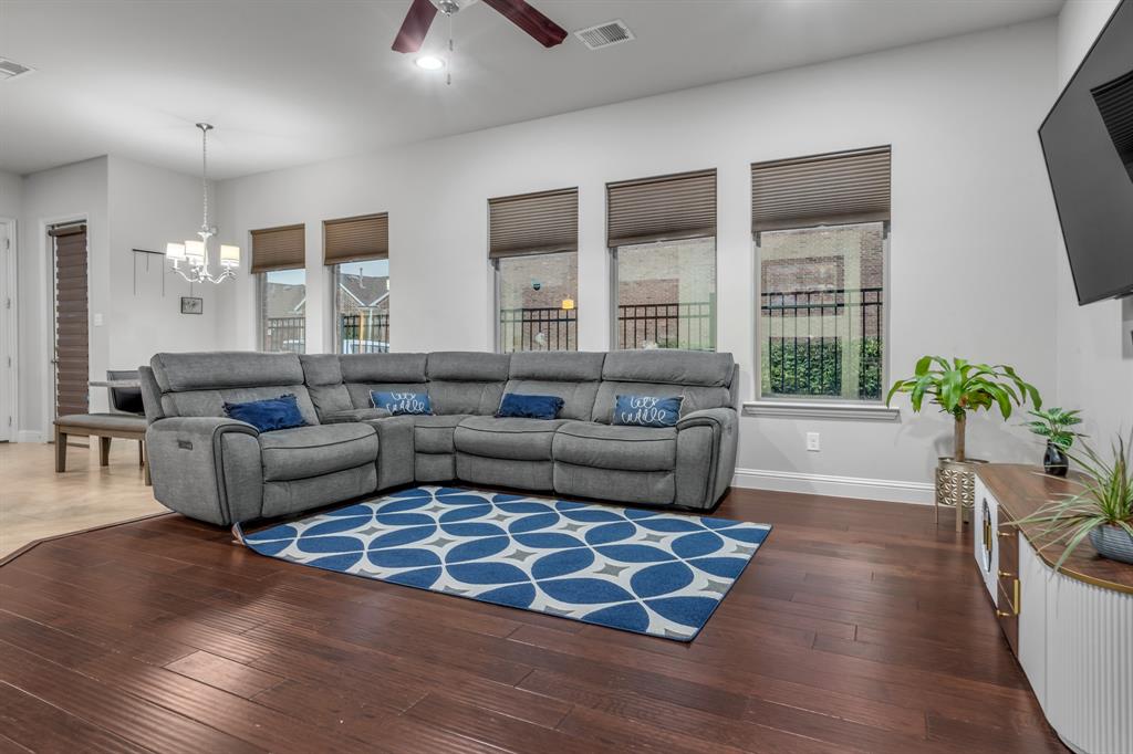 1229 Harris Hawk Way Arlington, TX 76005 - Photo 7 of 40 a living room with furniture wooden floor and a flat screen tv