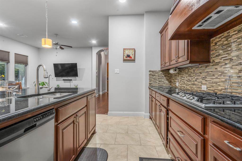 1229 Harris Hawk Way Arlington, TX 76005 - Photo 10 of 40 a kitchen with stainless steel appliances granite countertop a sink and a stove