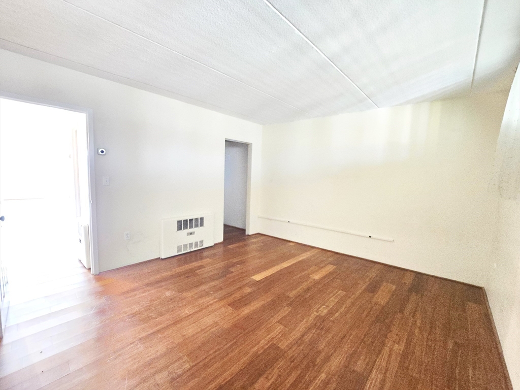 200 Swanton Street, Unit 318 Winchester, MA 01890 - Photo 6 of 9 a view of an empty room with wooden floor