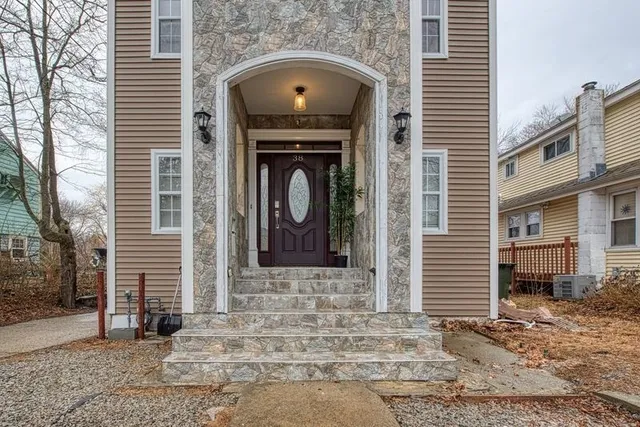a front view of a house with parking space