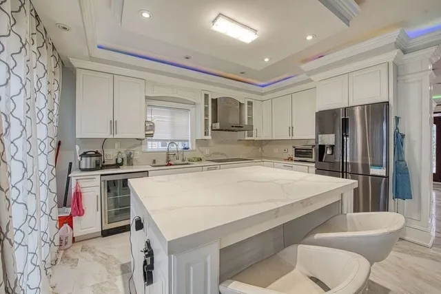 a kitchen with a table chairs refrigerator and microwave