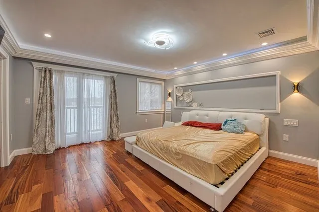 a room with a bed and a refrigerator