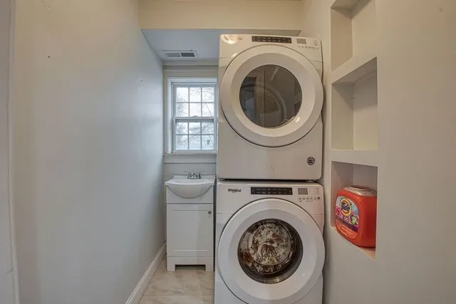 a living room with wooden floor and a window