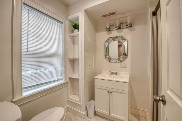 a view of a room with wooden floor and lounge chair