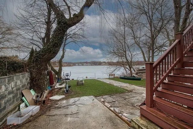 a view of a yard with wooden fence