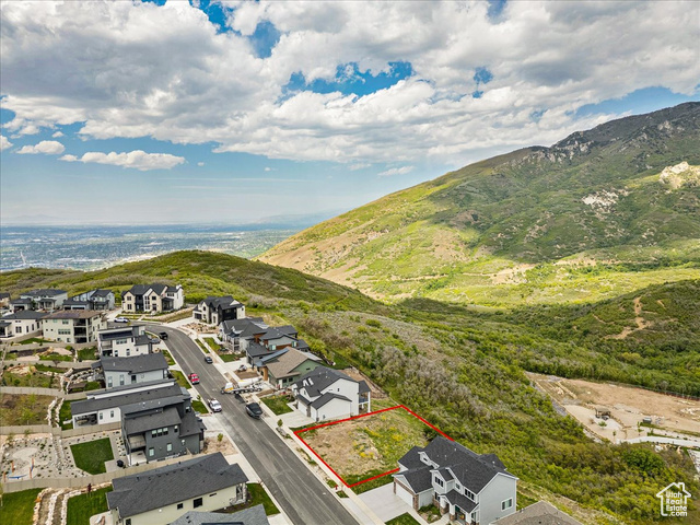 14673 South Ravine Rock Way East, Unit 720 Draper, UT 84020 - Photo 5 of 15 Aerial view of residential area with property boundaries highlighted and a mountain backdrop