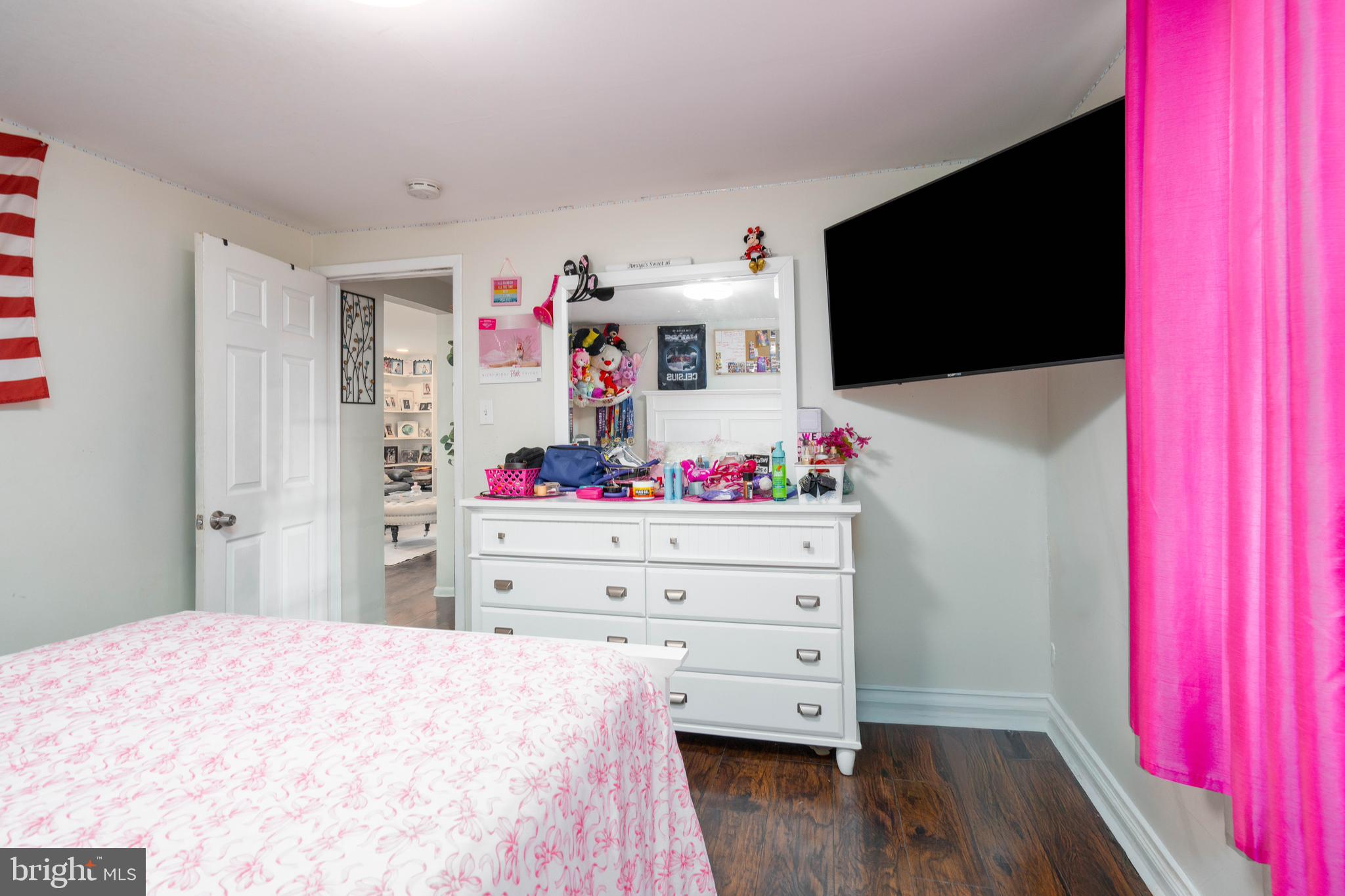 519 Clarendon Avenue Vineland, NJ 08360 - Photo 13 of 22 a bed room with a bed and a flat screen tv