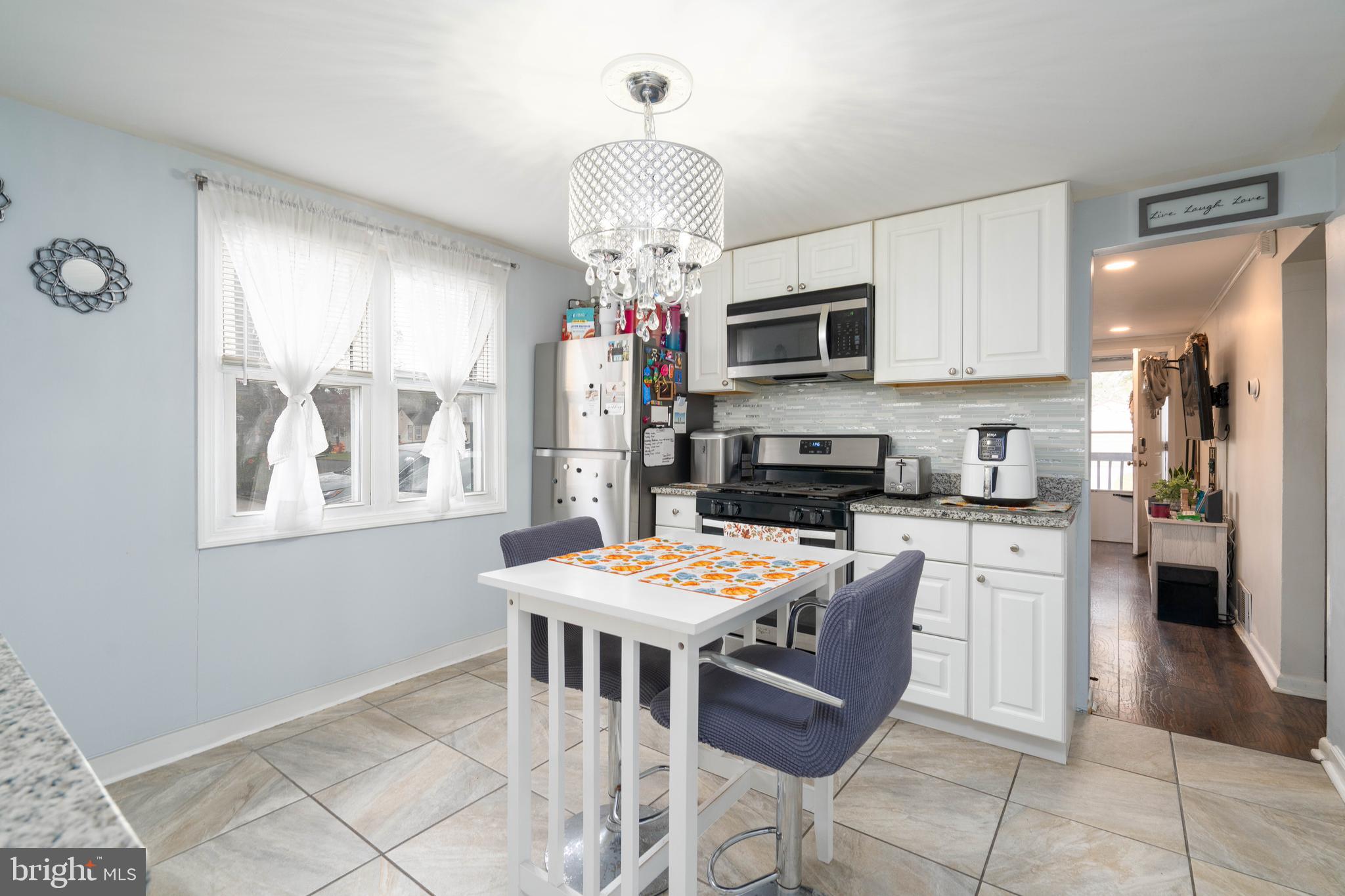 519 Clarendon Avenue Vineland, NJ 08360 - Photo 6 of 22 a kitchen with stainless steel appliances granite countertop a stove top oven a sink a dining table and chairs