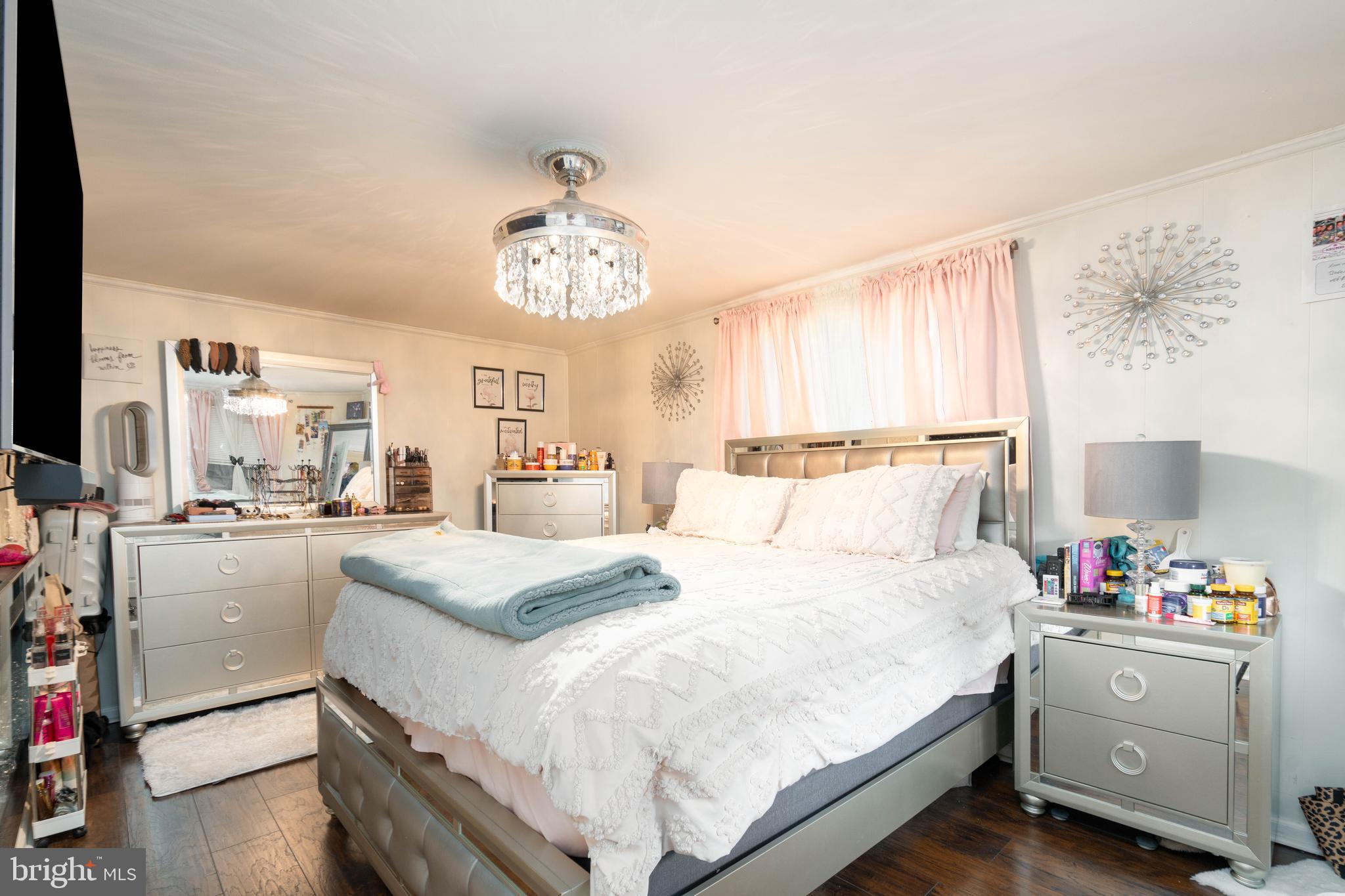 519 Clarendon Avenue Vineland, NJ 08360 - Photo 10 of 22 a bed room with a bed and a chandelier