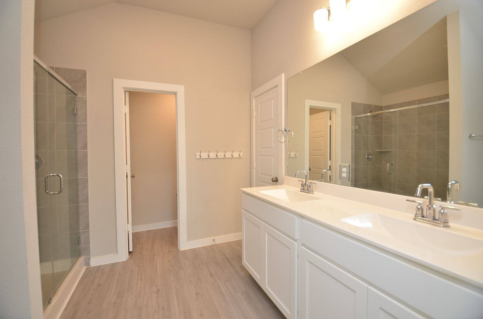 8230 Blue Fish Drive Cypress, TX 77433 - Photo 9 of 18 Primary bathroom has double sinks, a large walk in closet and an oversized shower with glass enclosure.