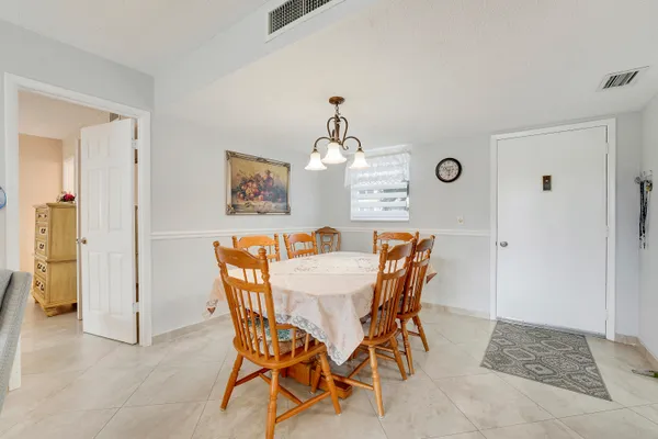 a view of a dining room with furniture and chandelier