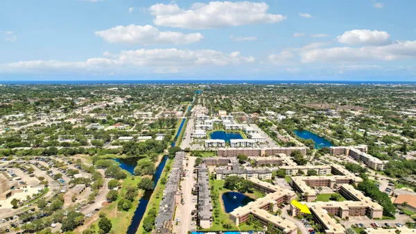 an aerial view of residential building with yard
