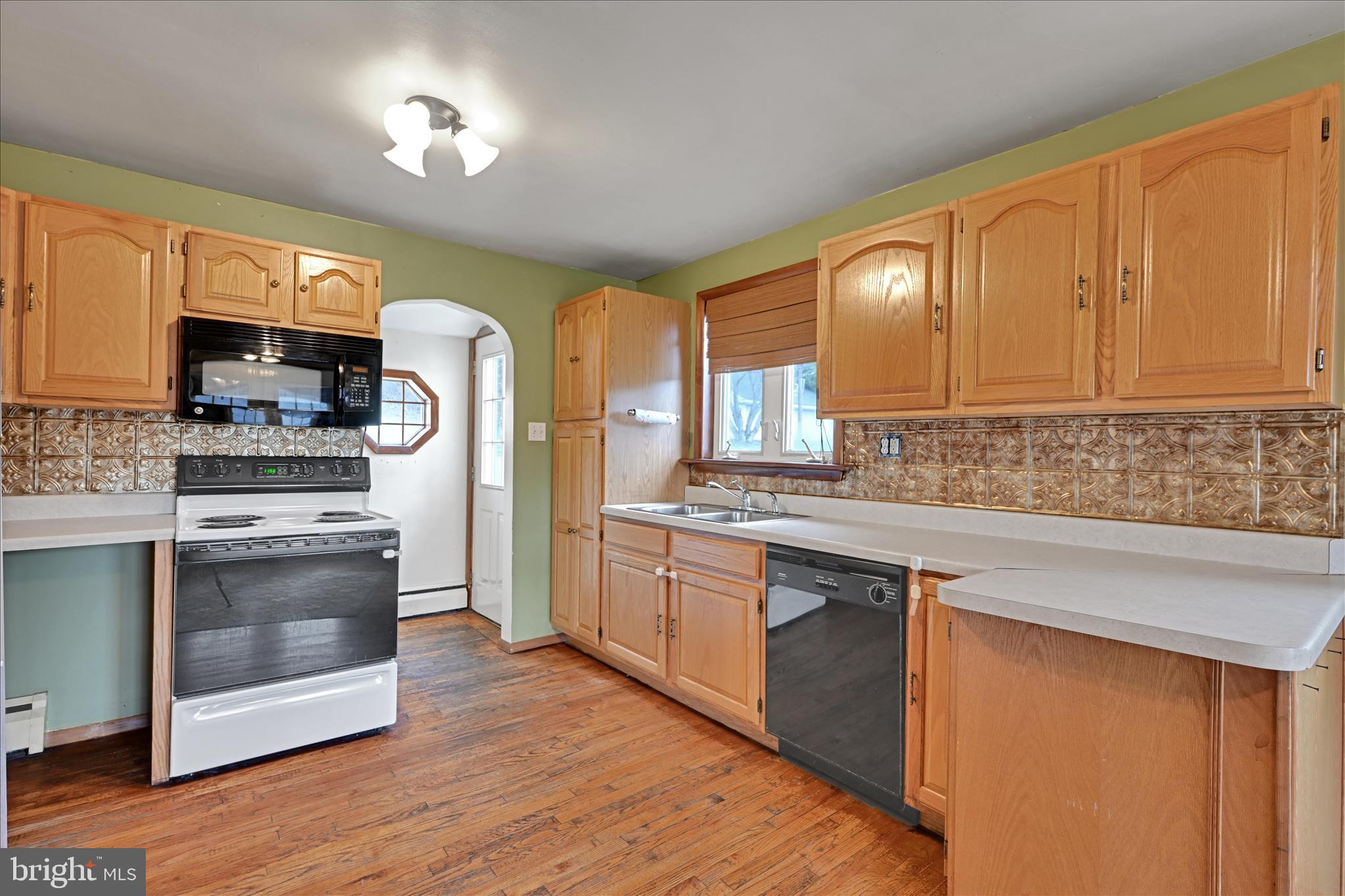1012 Fountain Street Ashland, PA 17921 - Photo 10 of 34 a kitchen with stainless steel appliances granite countertop a stove a sink dishwasher and a refrigerator with wooden floor