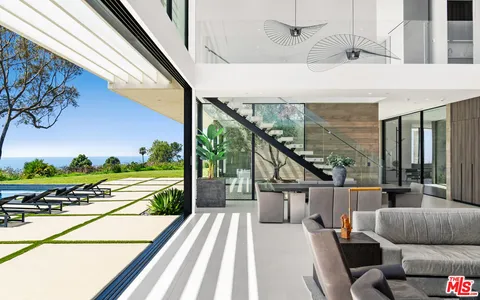 a view of a swimming pool with an outdoor space and seating area